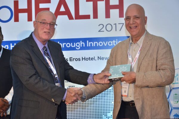 Dr Ronald Heslegrave presenting a memento to Dr Shiban Ganju at InnoHEALTH 2017 Dr Ronald Heslegrave presenting a memento to Dr Shiban Ganju at InnoHEALTH 2017