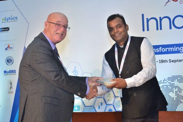 Dr Ronald Heslegrave presenting a memento to Ashish Gupta at InnoHEALTH 2017 Dr Ronald Heslegrave presenting a memento to Ashish Gupta at InnoHEALTH 2017