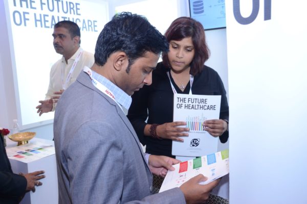 Anusha from GalaXe healthcare solutions briefing an attendee at InnoHEALTH 2017